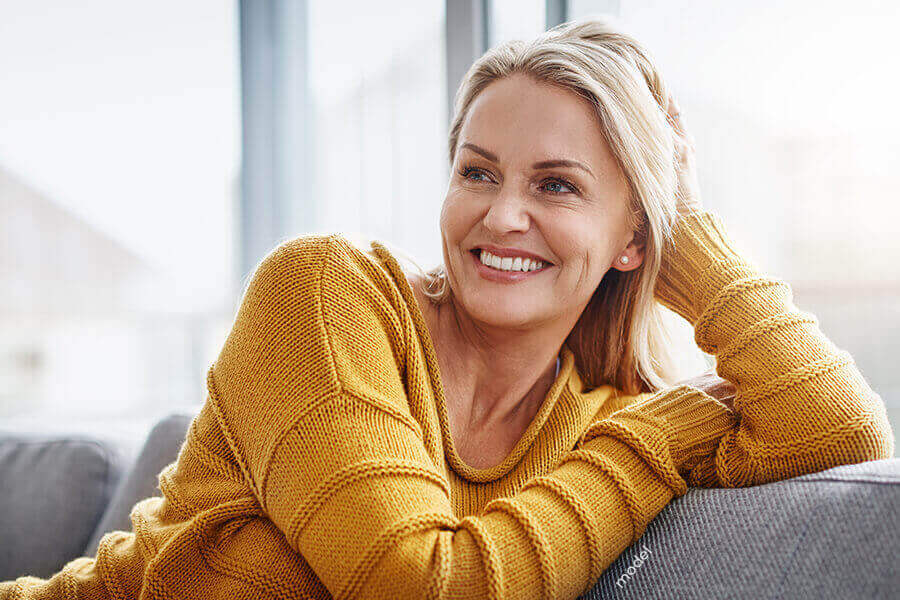 Woman reclining on couch.