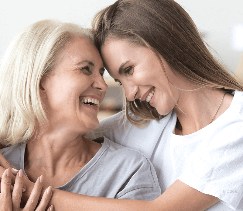 Mother and daughter embracing each other