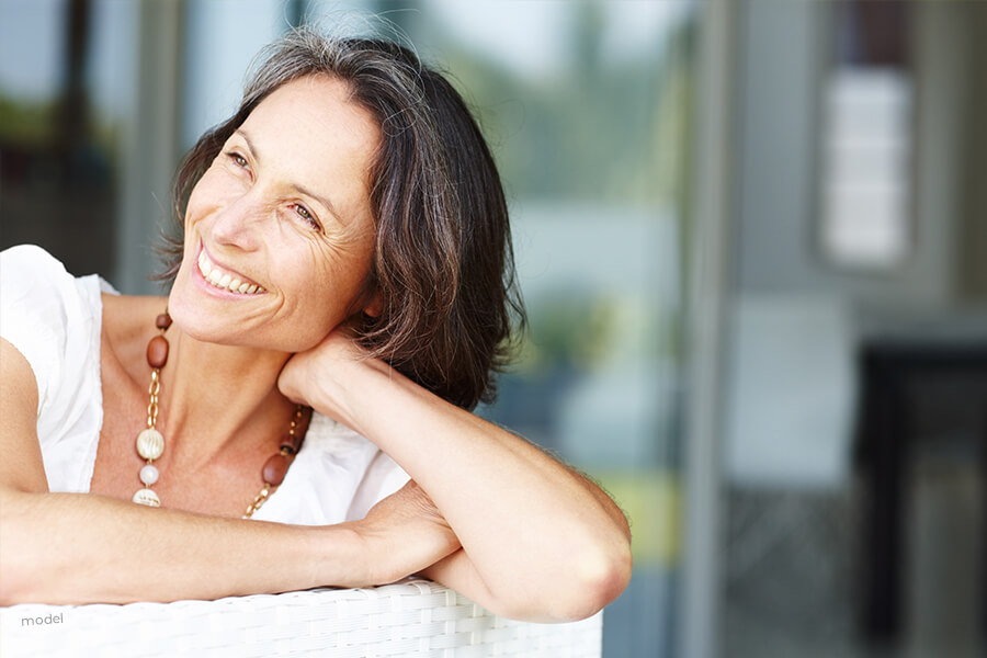 Woman with hand on neck.